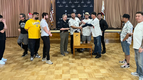 Frank congratulates Haik for winning! crowd surrounds